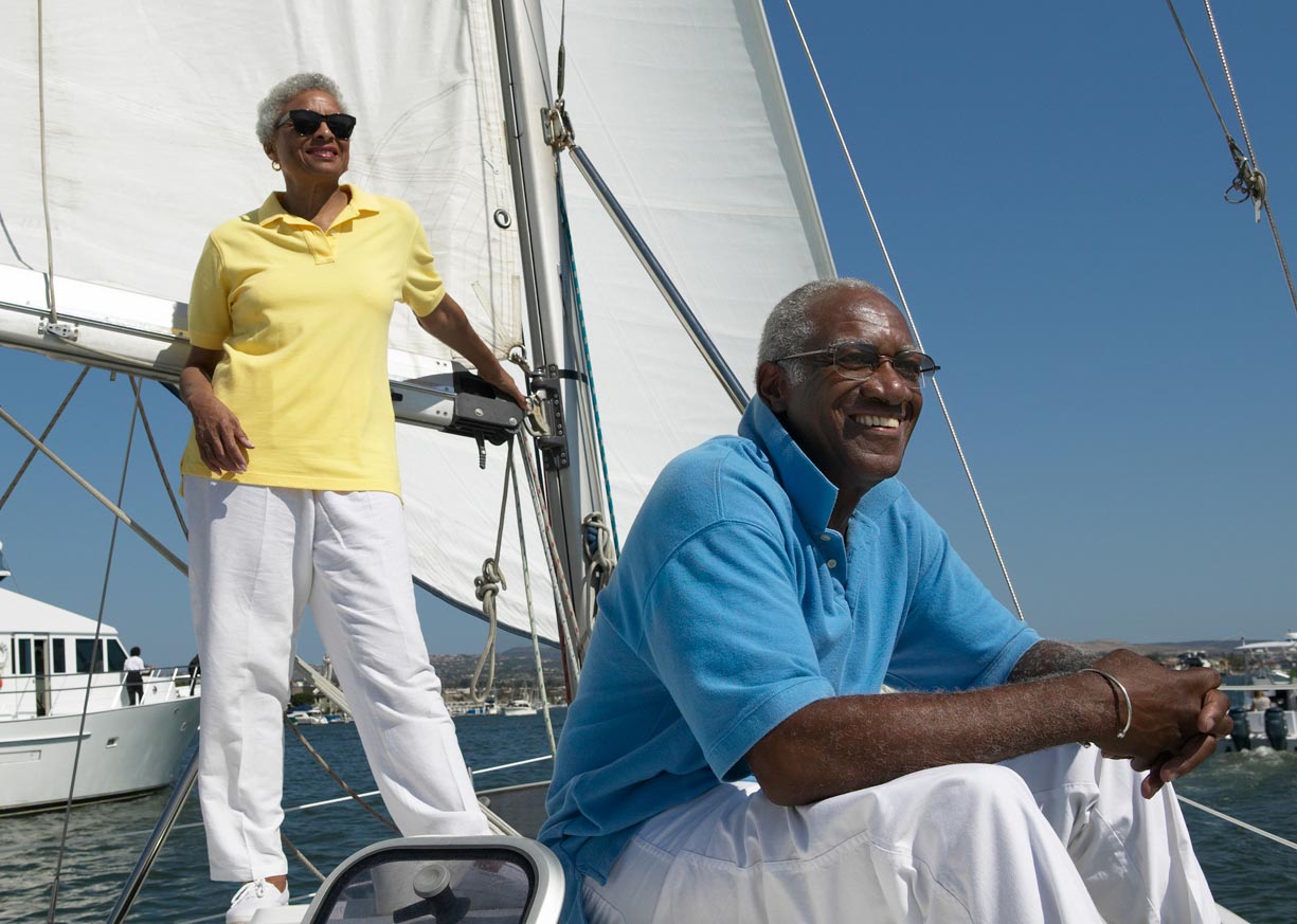 Diamond Checking account customers who are smiling and sailing their boat