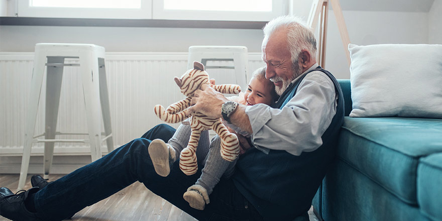 Man who has set up an IRA account is happily playing with his granddaughter