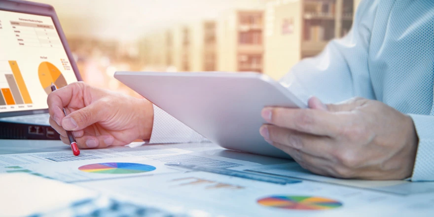 Close up of a businessman working with a laptop to review payments received through integrated account receivables