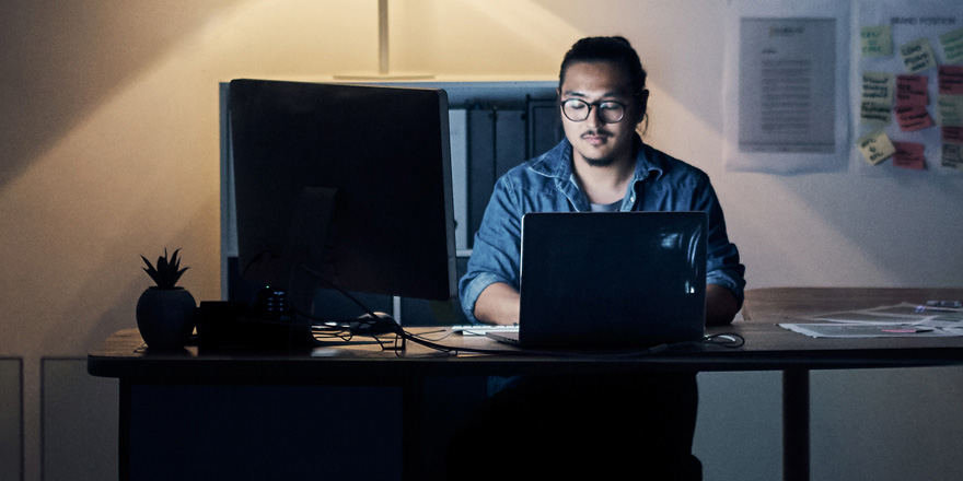 A small business owner is working in his office after receiving needed cash flow through a structured finance program