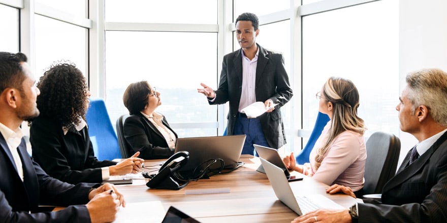 A group of several employees meet to discuss the benefits of an Employee Stock Ownership Plan or ESOP