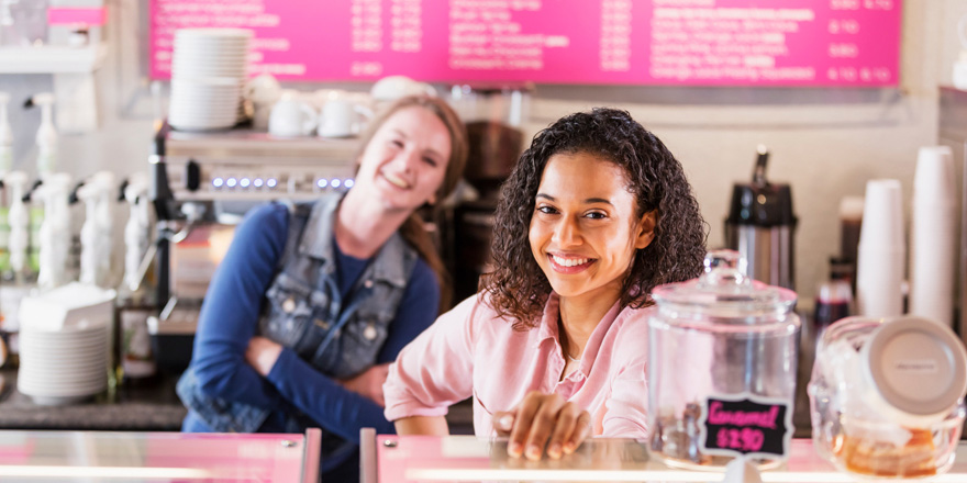 Two business owners opened a restaurant and are smiling after receiving financing through the franchise banking program