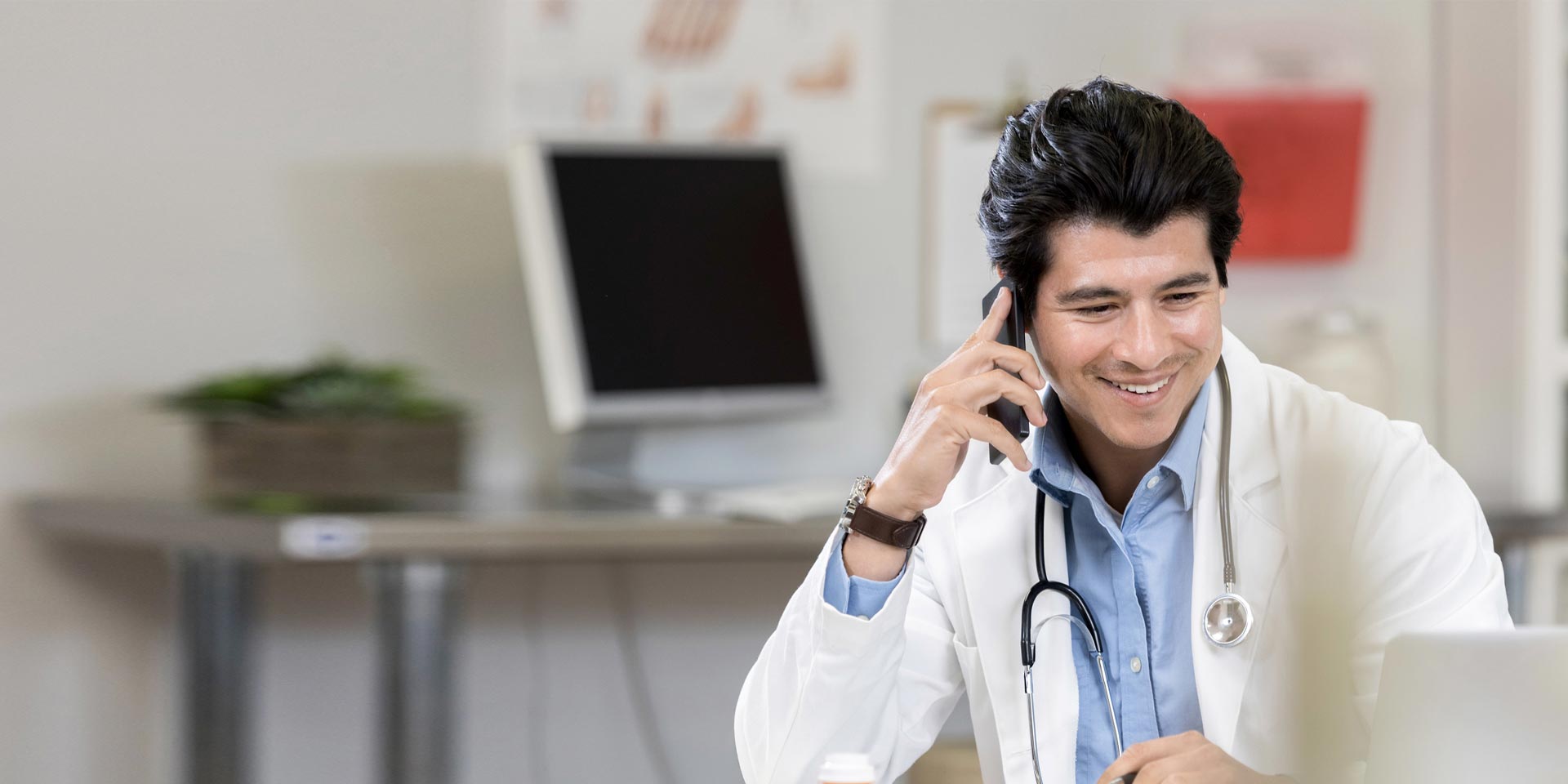 A medical professional uses his cell phone to discuss healthcare financing options