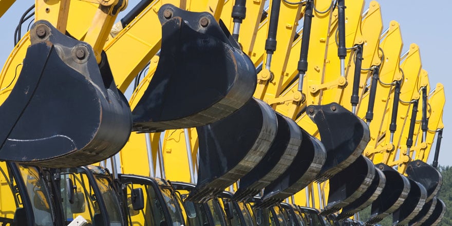 A row of new motorized construction equipment that was purchased with financing from an asset-based lending program