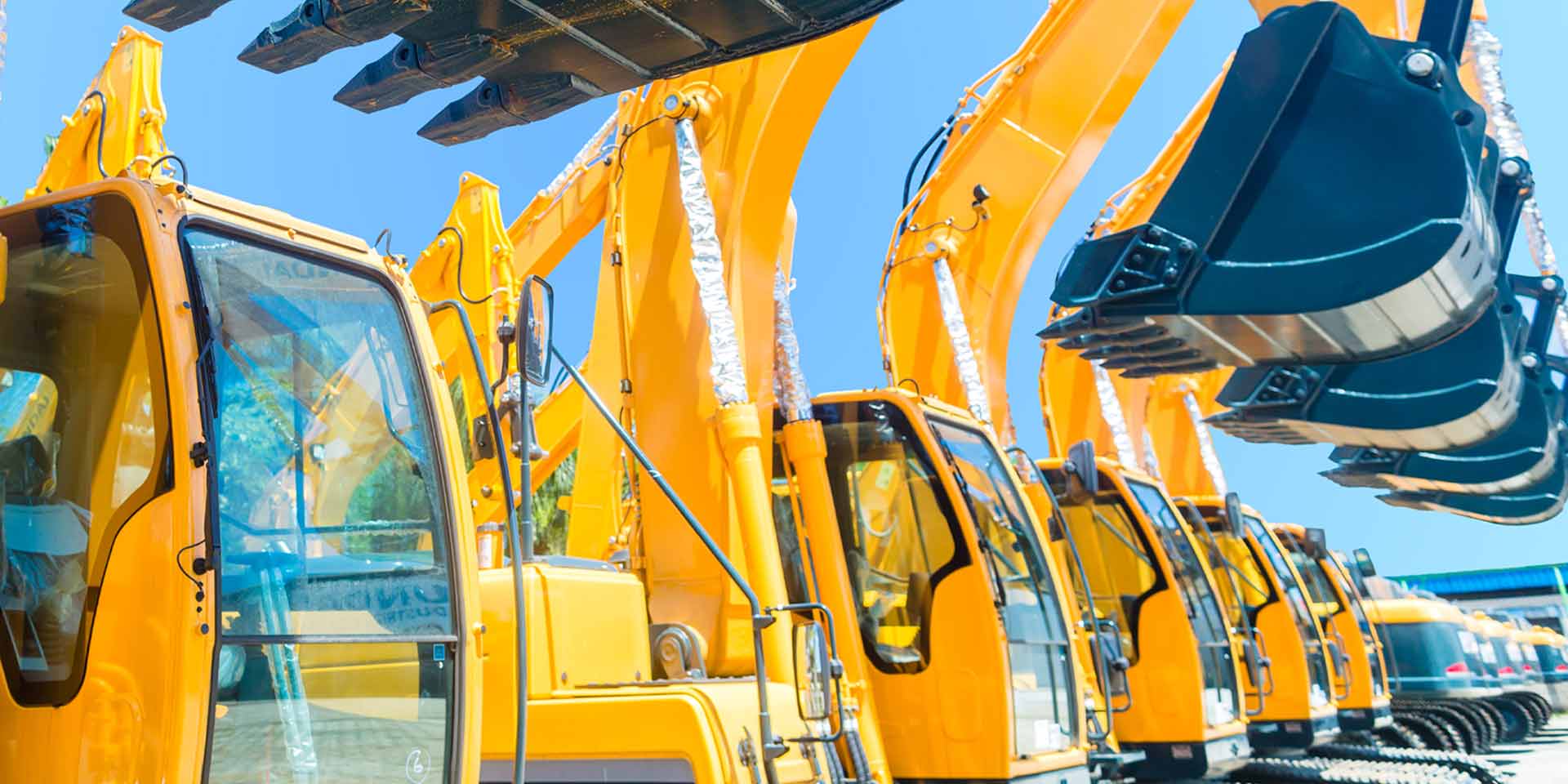 Several construction vehicles are lined up and ready to use after having been purchased through equipment financing