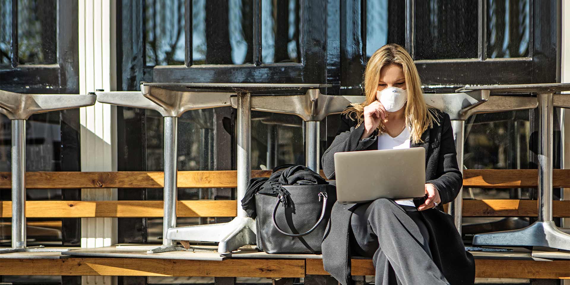 Woman outside on her laptop