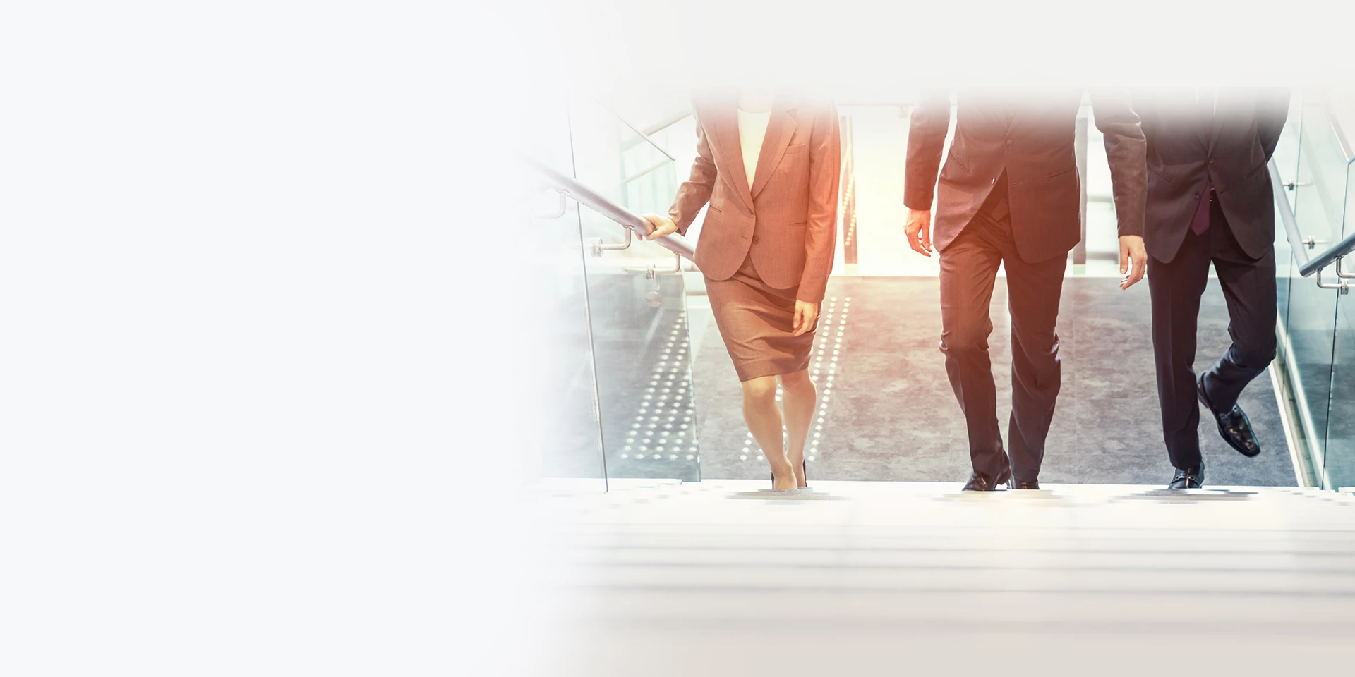 First Midwest’s Leadership Team are walking up the stairs of a modern building