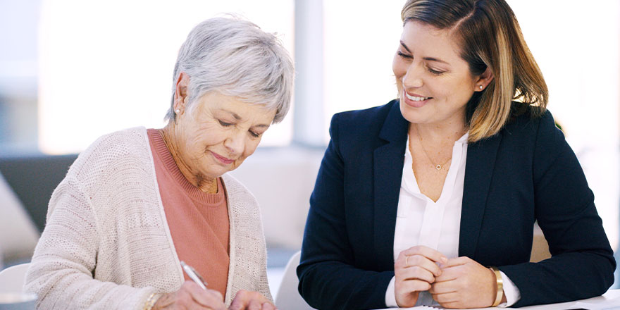 Older woman signing documents