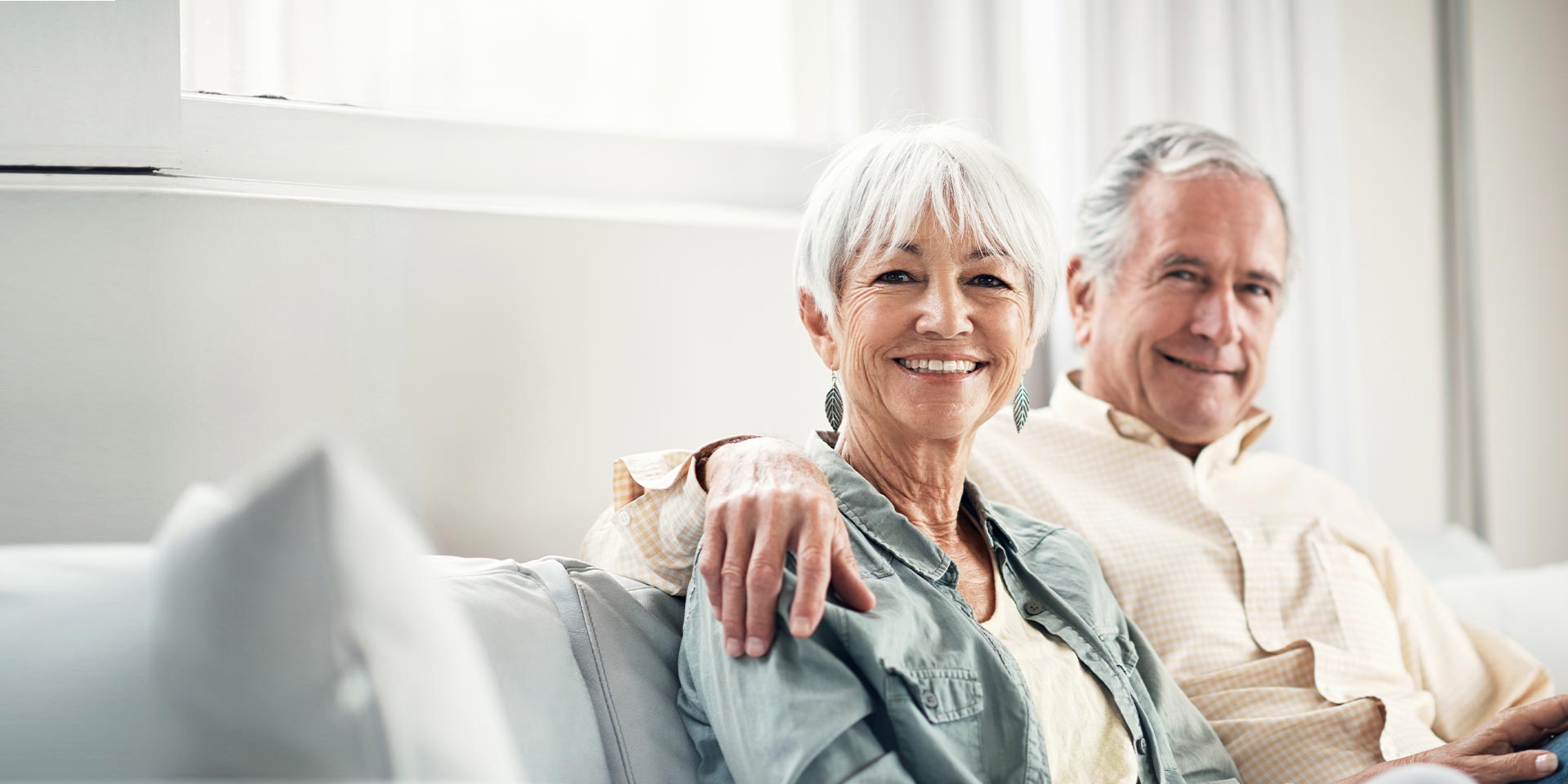 A happy older couple embrace and are confident with their retirement plan