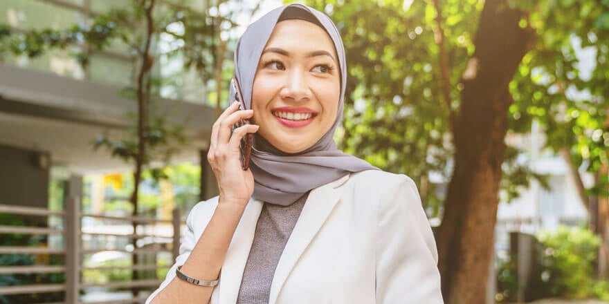 A young lady using a mobile phone to call for Priority Customer Service